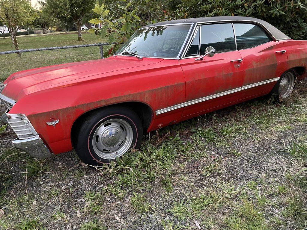 1967 Chevrolet Impala Sport Sedan sits